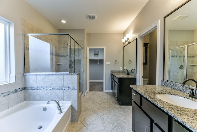 bathroom with tile patterned floors, separate shower and tub, and vanity