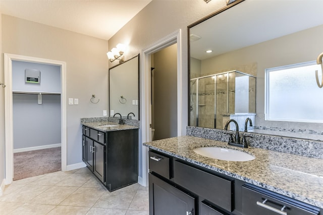 bathroom featuring tile patterned floors, vanity, and walk in shower