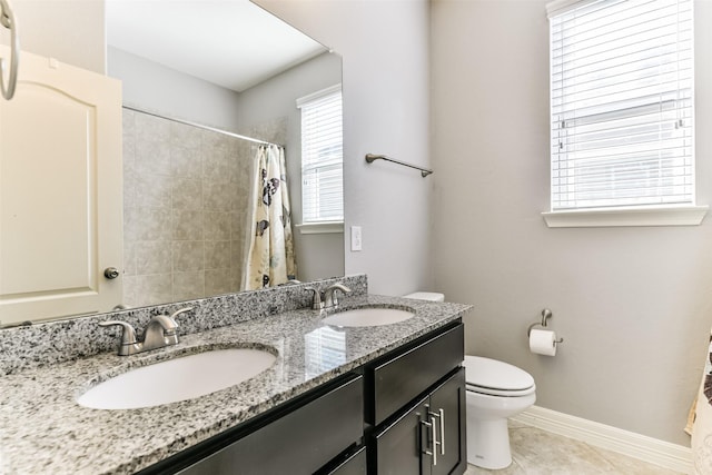 bathroom featuring toilet, vanity, a shower with curtain, and tile patterned flooring