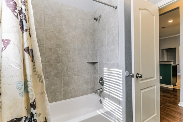 bathroom with shower / tub combo, crown molding, and hardwood / wood-style flooring