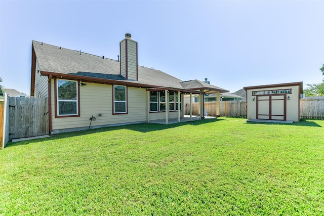 back of property featuring a yard, a storage shed, and a patio