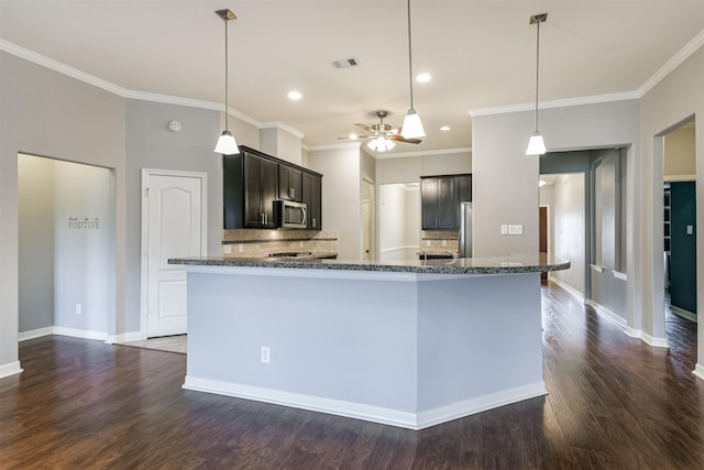 kitchen with stainless steel appliances, tasteful backsplash, ornamental molding, ceiling fan, and dark brown cabinets