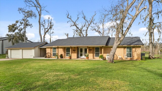 single story home featuring covered porch, a front yard, and a garage