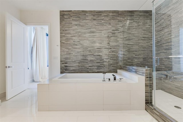 bathroom featuring tile patterned floors, independent shower and bath, and tile walls