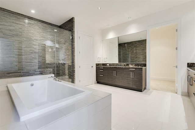 bathroom with tile patterned flooring, vanity, and independent shower and bath