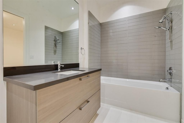 bathroom featuring tile patterned floors, vanity, and tiled shower / bath combo