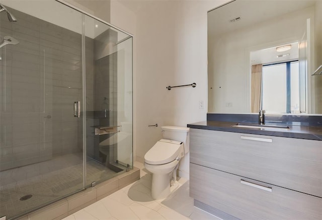 bathroom with tile patterned floors, vanity, an enclosed shower, and toilet