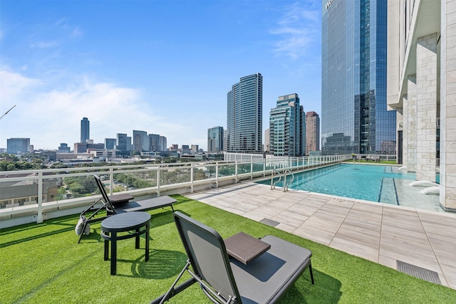 view of pool featuring a patio area and a yard