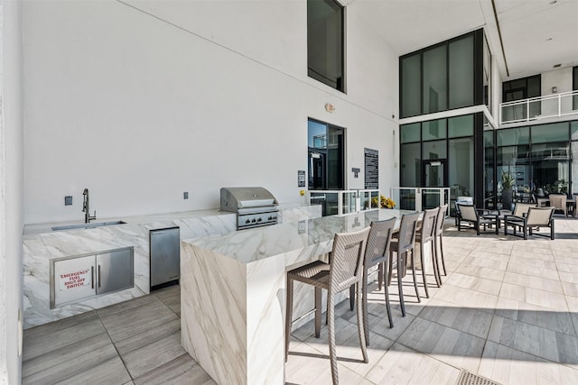 view of patio featuring area for grilling, grilling area, and a wet bar