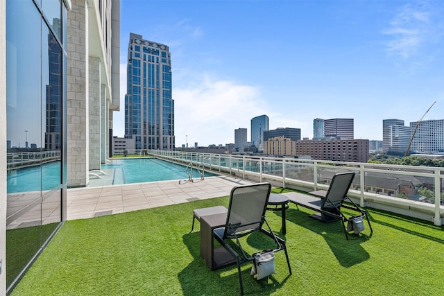 view of swimming pool with a lawn