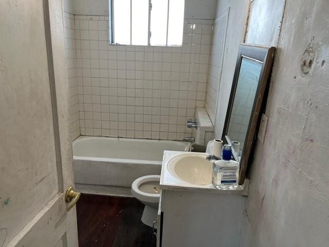 full bathroom with vanity, tiled shower / bath, and toilet