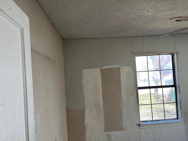 interior details featuring a textured ceiling