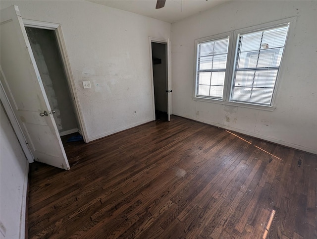 unfurnished bedroom with dark wood-style floors and a ceiling fan