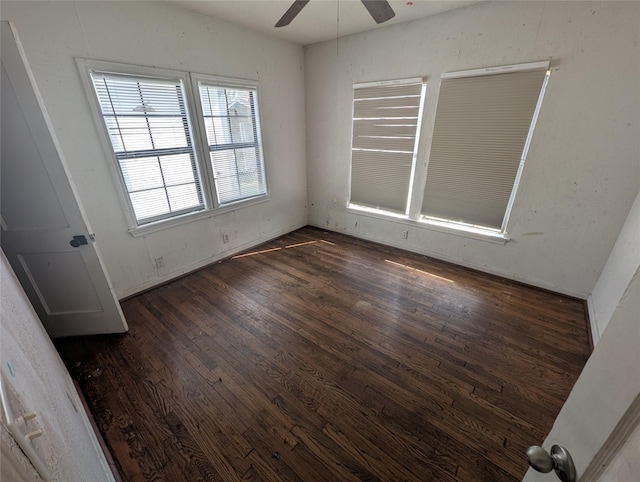 unfurnished room with dark wood-type flooring and a ceiling fan