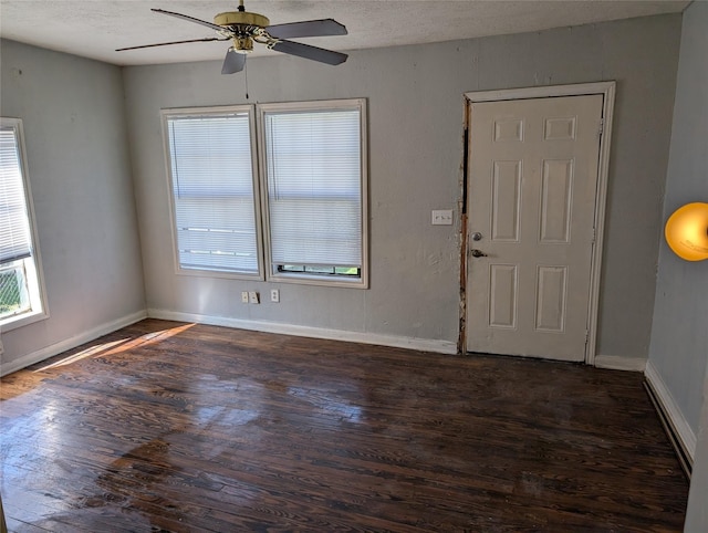 foyer entrance featuring a wealth of natural light, baseboards, and wood finished floors