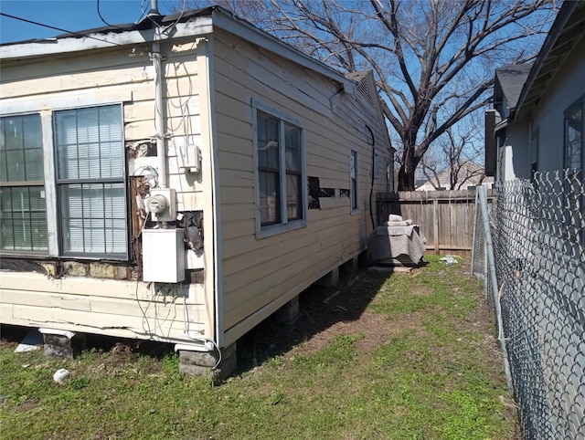 view of home's exterior featuring fence