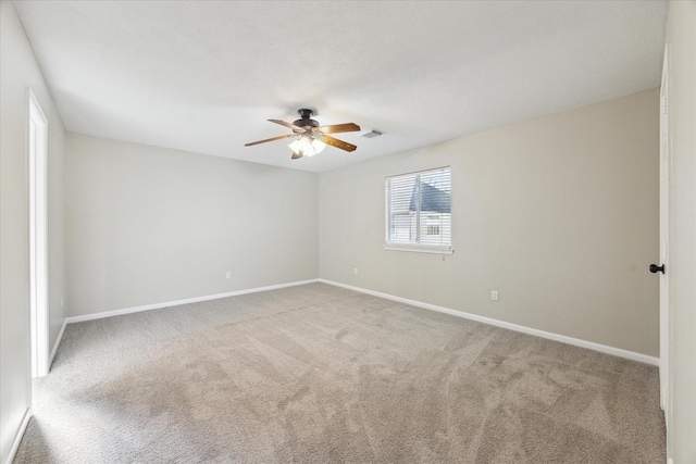 carpeted spare room with ceiling fan