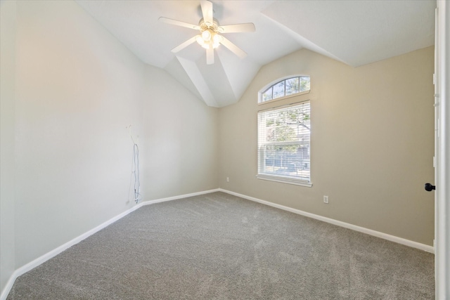 carpeted empty room with ceiling fan and vaulted ceiling