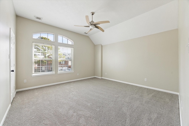 spare room with carpet flooring, ceiling fan, and vaulted ceiling