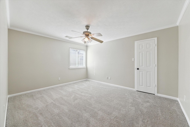 carpeted empty room featuring ceiling fan and ornamental molding