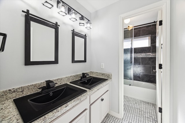 bathroom featuring vanity and tiled shower / bath