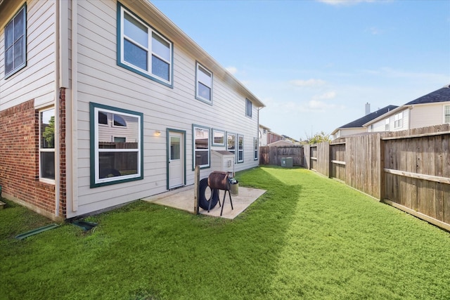 rear view of house featuring a yard and a patio