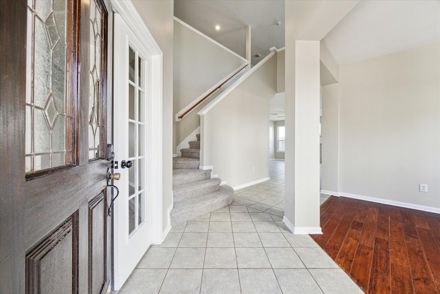 tiled foyer entrance with lofted ceiling