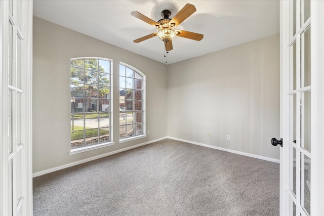 spare room featuring carpet flooring, a wealth of natural light, french doors, and ceiling fan