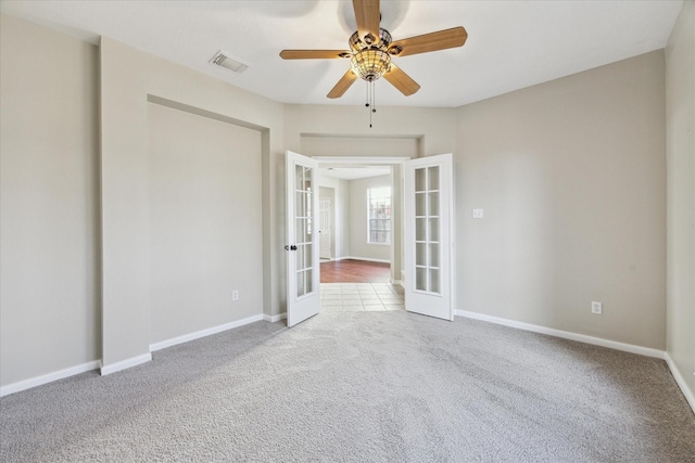 unfurnished room with french doors, carpet floors, and ceiling fan