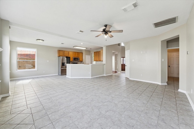 unfurnished living room with ceiling fan and light tile patterned floors