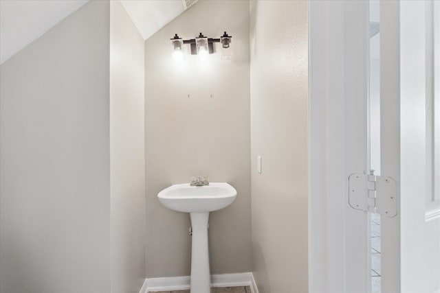 bathroom with lofted ceiling