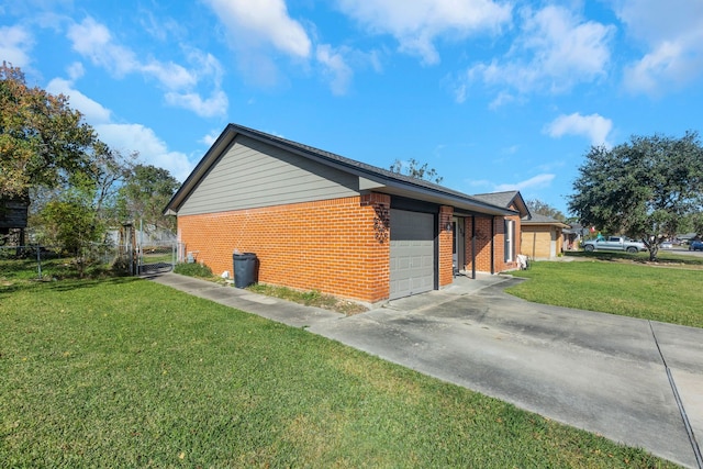 view of side of property with a garage and a lawn