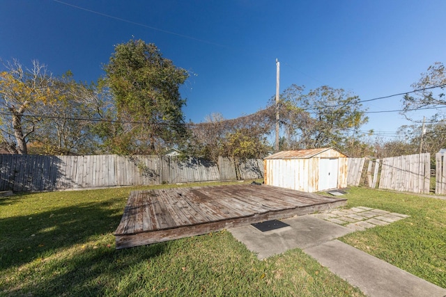 view of yard featuring a shed and a wooden deck