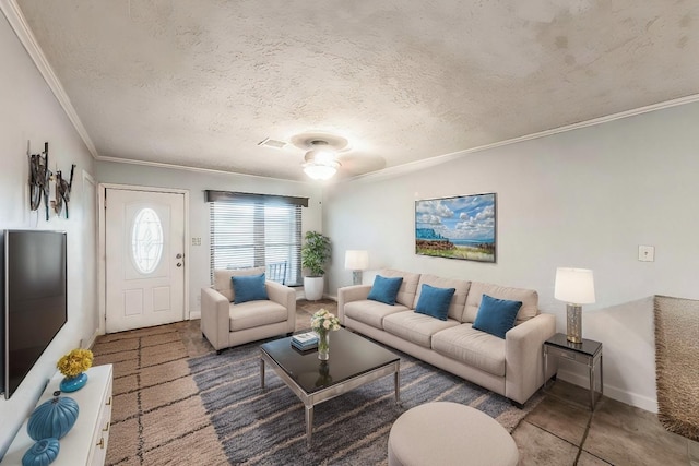 living room featuring ornamental molding, ceiling fan, and a textured ceiling