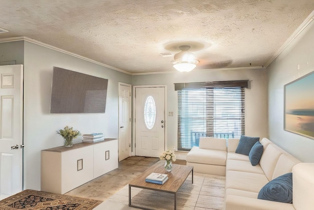 living room featuring crown molding, ceiling fan, and a textured ceiling