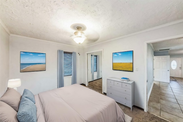 bedroom with crown molding, a textured ceiling, and ceiling fan