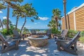 view of patio featuring a water view and an outdoor fire pit