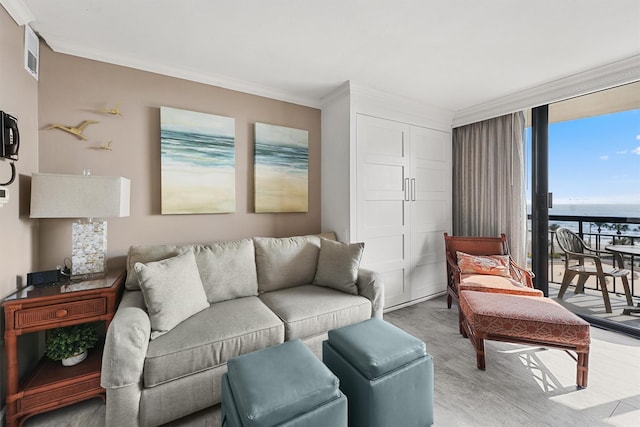 living room featuring floor to ceiling windows, crown molding, a water view, and wood-type flooring