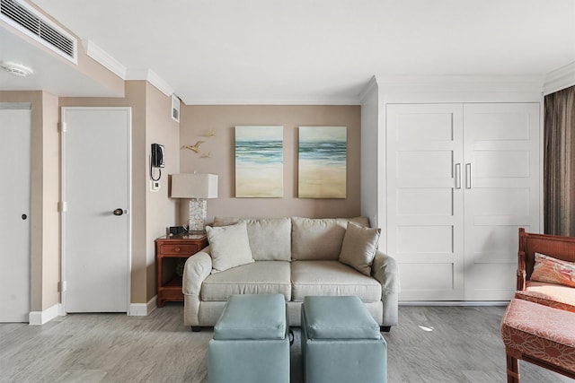 living room featuring light hardwood / wood-style floors and crown molding