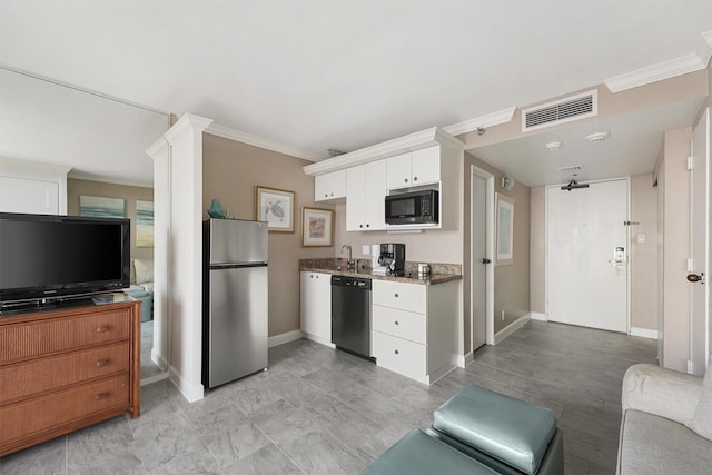 kitchen with white cabinetry, sink, dark stone counters, black appliances, and ornamental molding