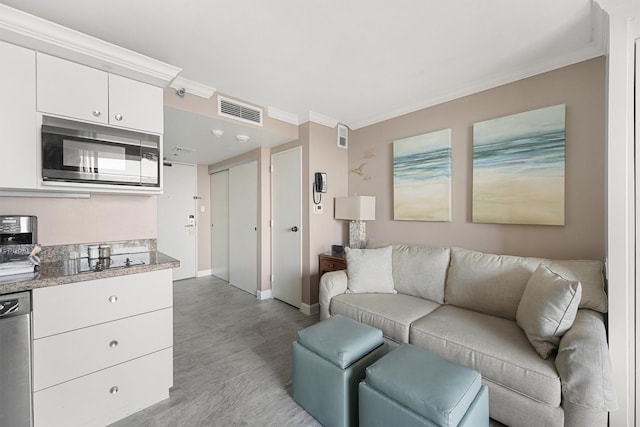 living room featuring crown molding