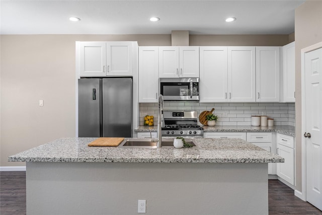 kitchen with white cabinetry, an island with sink, and appliances with stainless steel finishes