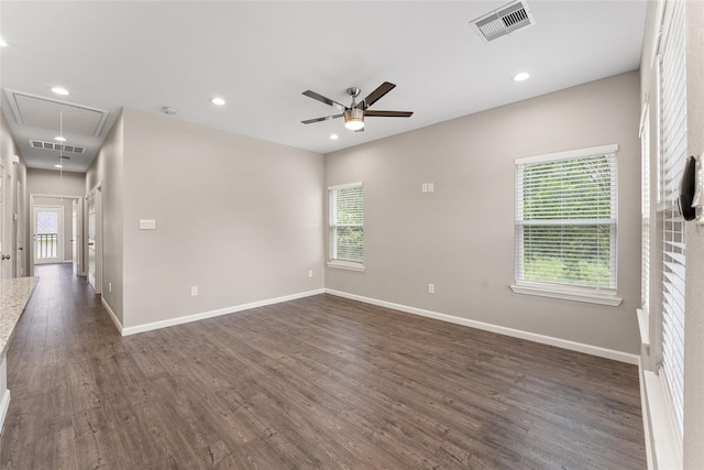 empty room with ceiling fan and dark hardwood / wood-style flooring