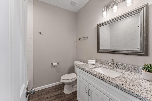 bathroom with vanity, toilet, wood-type flooring, and walk in shower