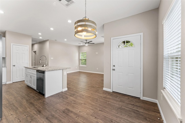 kitchen featuring dishwasher, sink, hanging light fixtures, dark hardwood / wood-style flooring, and white cabinetry