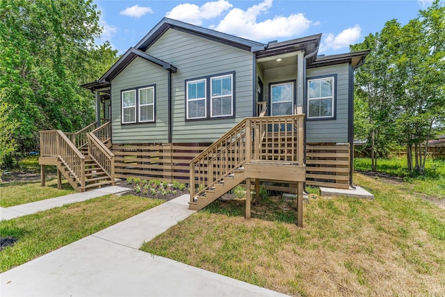 back of house featuring a yard and a wooden deck