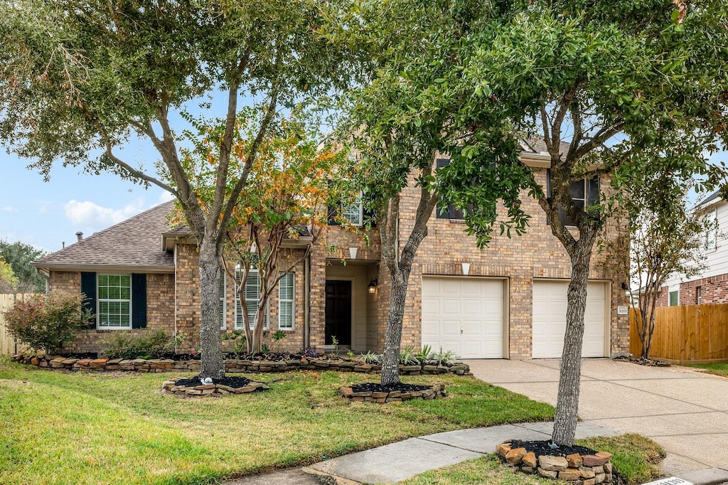 view of front facade with a front yard and a garage