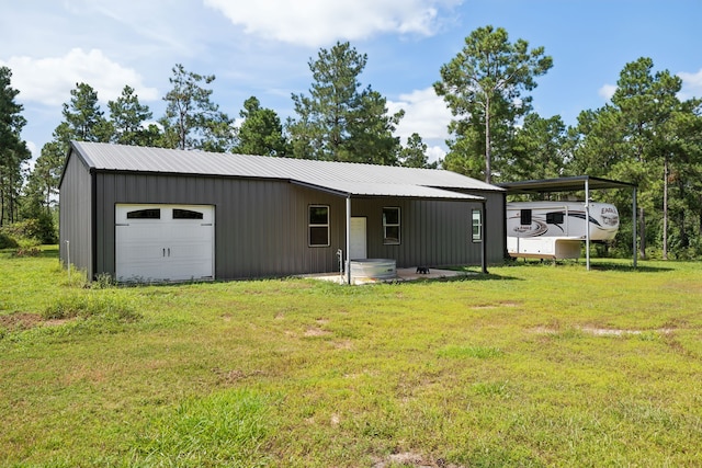 view of front of house with a garage, an outdoor structure, and a front lawn