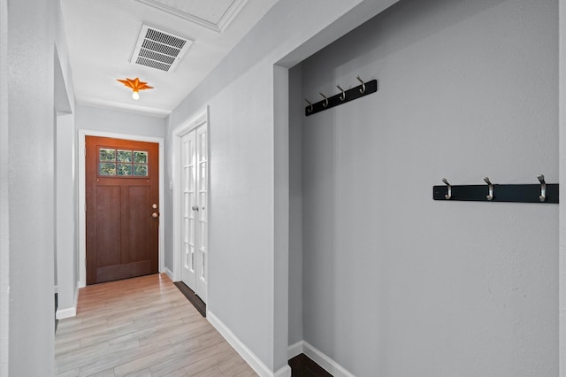 doorway to outside with light wood-type flooring