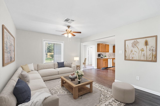 living room featuring wood-type flooring and ceiling fan